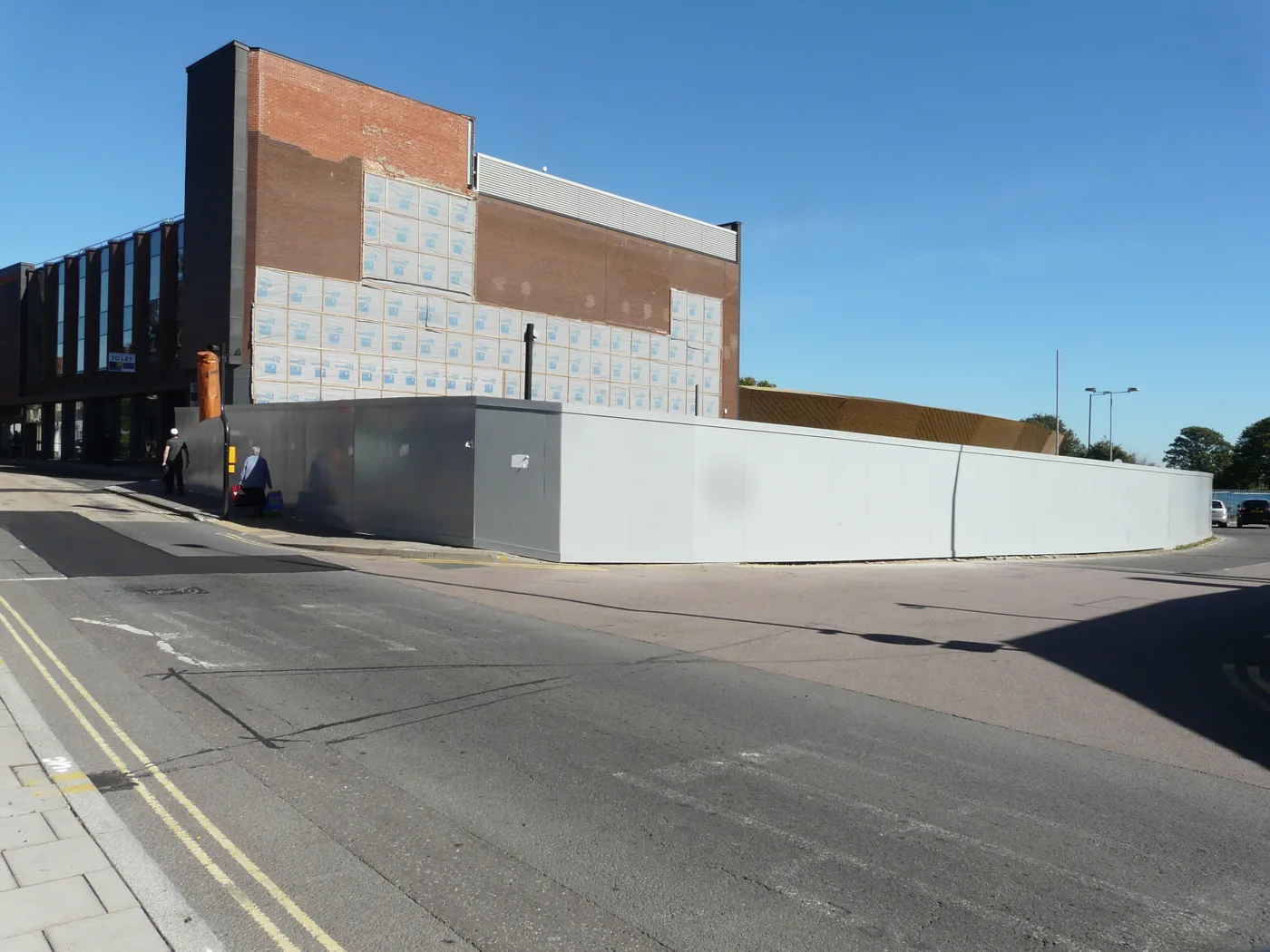 Queen Street in September 2018: hoardings around the development site by the former bus station land, with Firstsite's gold roof behind. The photo predates the current plans.